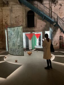 Installation view of a work with Palestinian flags hanging in the Arsenale.